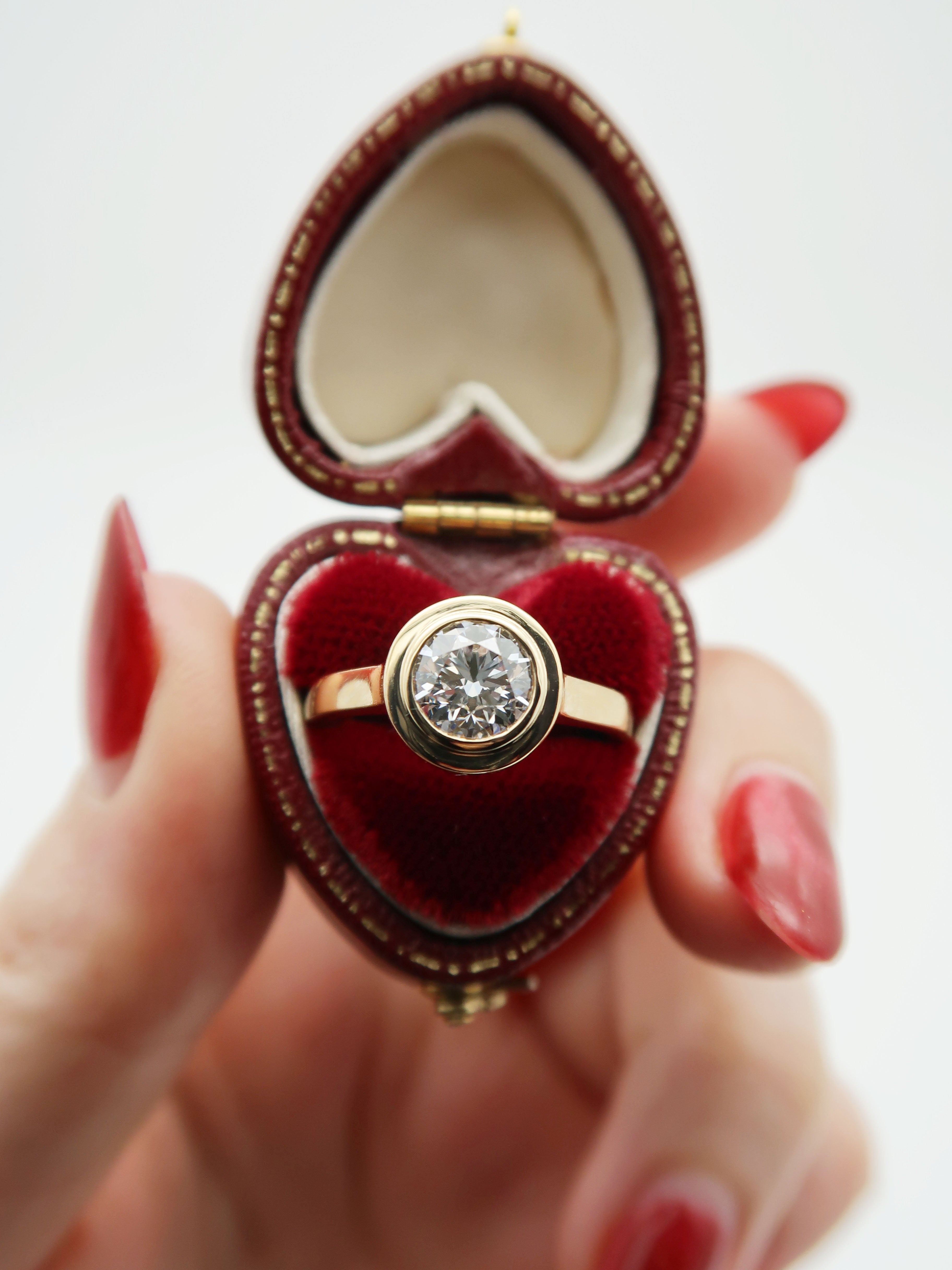 Custom 14K yellow gold engagement ring featuring a round brilliant cut lab diamond set in a sleek and stunning floating double bezel. This ring was commissioned by an old friend from high-school, and it was such an honour to create it for her!