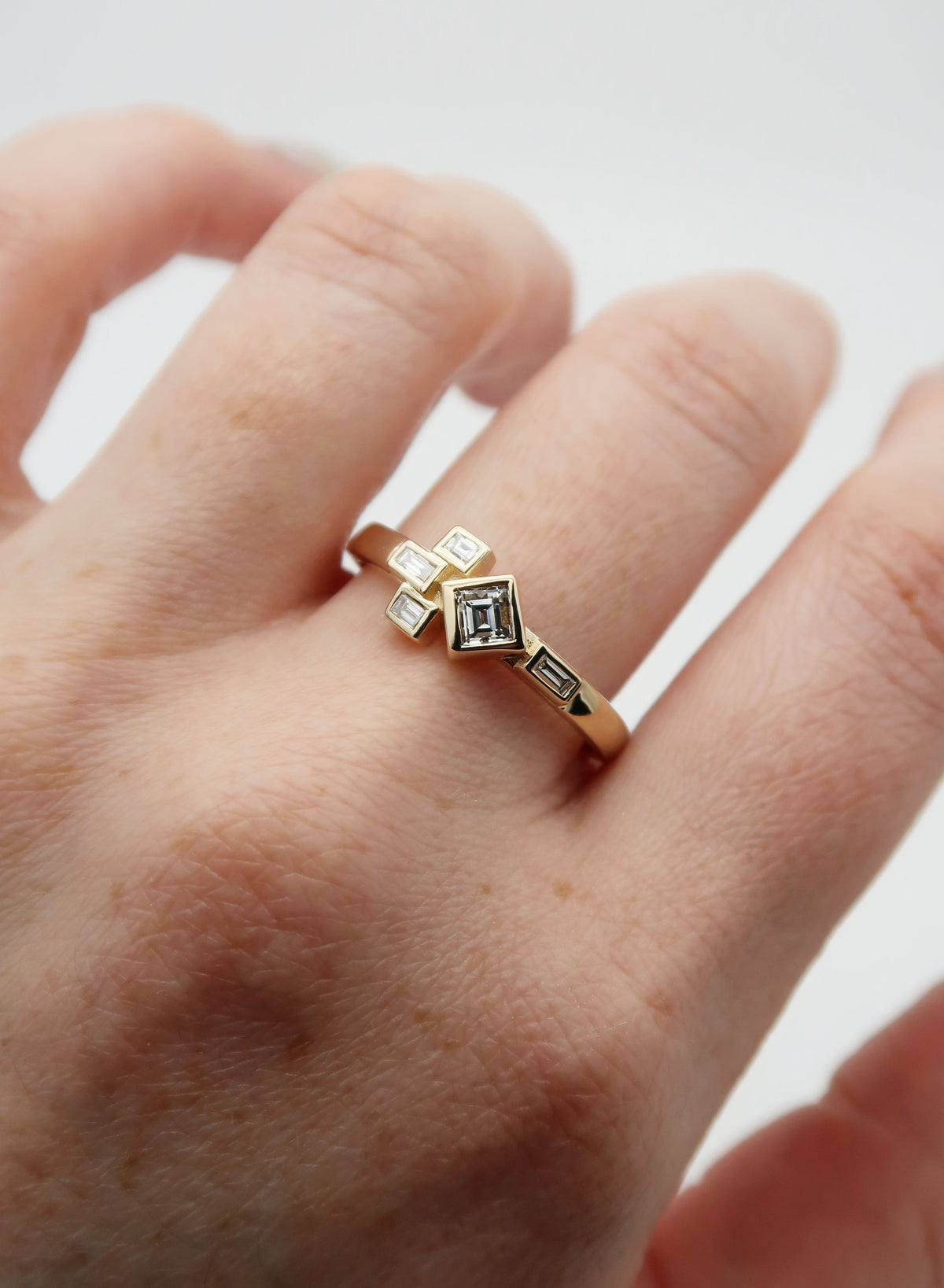 Custom yellow gold, heirloom diamond redesign. My client chose to re-use the diamonds from her engagement ring from a previous marriage to create a new piece that symbolizes her past, present and future.