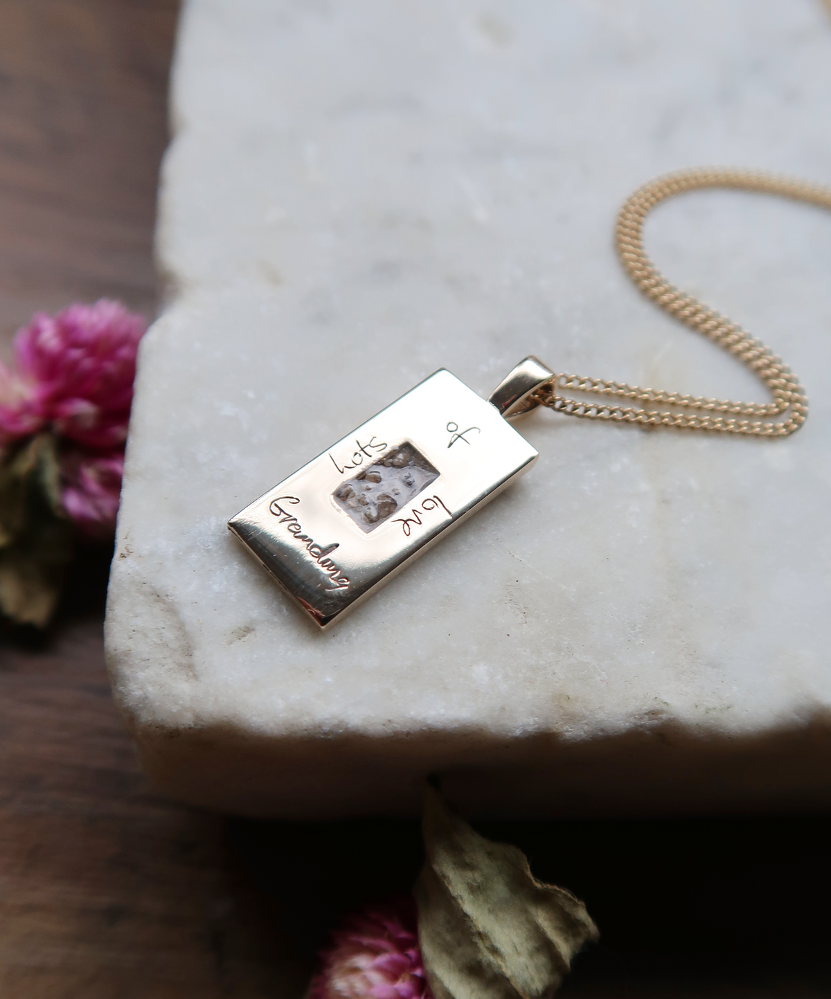 A very sentimental custom piece, incorporating my client’s late grandmother's ashes set in the heart of the pendant. Framing the ashes are the words, “Lot’s of Love, Grandma,” engraved in the actual hand-writing of my client’s late grandmother. We were able to carefully replicate the text from an old birthday card.