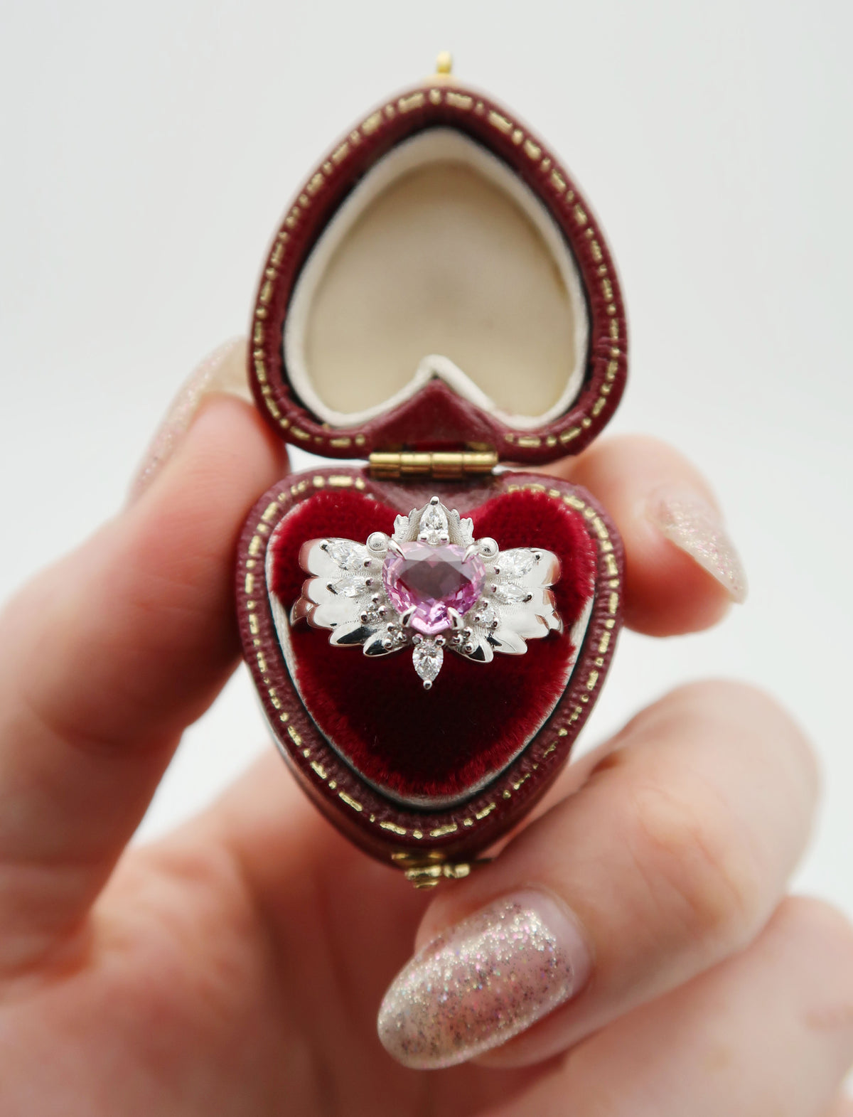Custom 14k white gold and pastel coloured, heart-cut sapphire and diamond engagement ring. This whimsical, winged design was inspired by Cardcaptor Sakura, a popular anime show that my client’s partner loved as a child! 