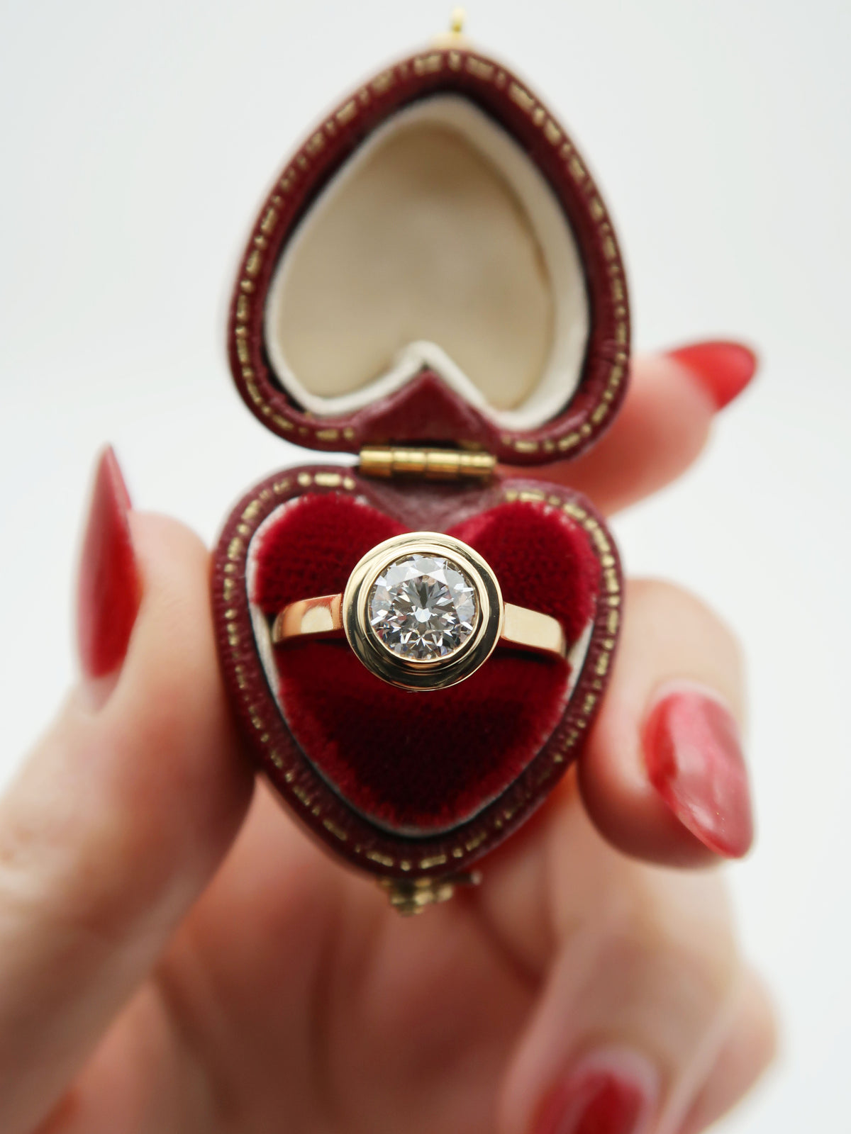 Custom 14K yellow gold engagement ring featuring a round brilliant cut lab diamond set in a sleek and stunning floating double bezel. This ring was commissioned by an old friend from high-school, and it was such an honour to create it for her!