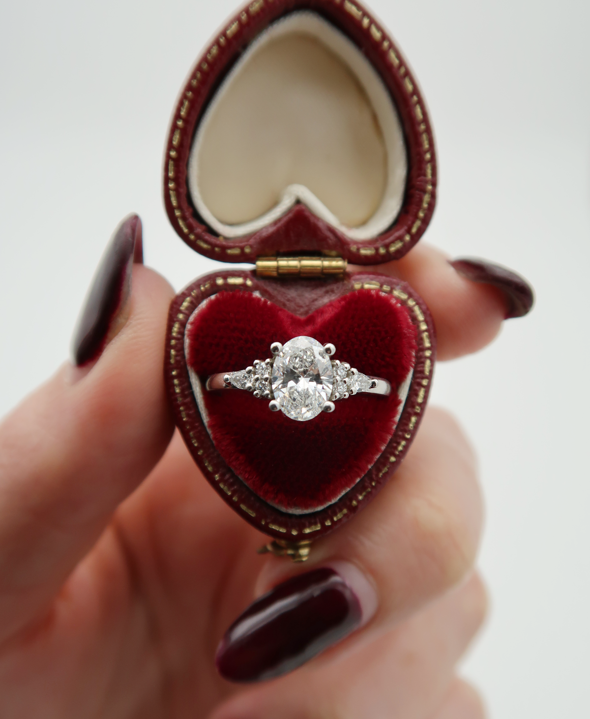 A customized version of one of our most population engagement ring styles, this time cast in 14k white gold with an oval cut lab diamond centre stone flanked by delicate diamond clusters. The white gold setting almost disappears in this piece, allowing the stones to shine even brighter than usual!
